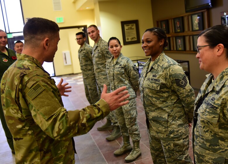 Chief Master Sgt. Joseph Montgomery, Air Force Central Command command chief, speaks with a top performer Jan. 8, 2017, at Creech Air Force Base, Nev. Montgomery coined several 432nd Wing/432nd Expeditionary Wing and 799th Air Base Group outstanding Airmen. (U.S. Air Force photo/Senior Airman Christian Clausen)