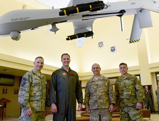 Chief Master Sgt. Jaime Auger, 432nd Wing/432nd Air Expeditionary Wing command chief, Col. Julian Cheater, 432nd WG/432nd AEW commander, Lt. Gen. Jeffrey Harrigian, Air Forces Central Command commander, and Chief Master Sgt. Joseph Montgomery, Air Force Central Command command chief, take a photo Jan. 8, 2017, at Creech Air Force Base, Nev. Harrigian visited with the 432nd WG/432nd AEW and 799th Air Base Group Airmen who deliver persistent attack and reconnaissance 24/7/365 against the nation’s enemies. (U.S. Air Force photo/Senior Airman Christian Clausen)