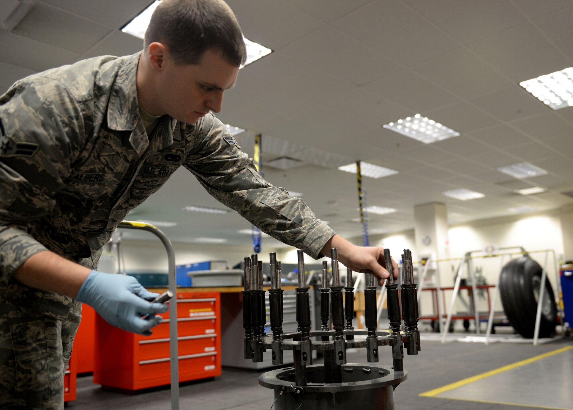 Airman 1st Class Clark Albers, C-17 Globemaster III crew chief and aerospace maintenance journeyman, sets up lugs using a wheel and tire assembly fixture in the Wheel and Tire Shop at Joint Base Elmendorf-Richardson, Alaska December 18, 2017. Crew chiefs inspect, assemble and disassemble all wheels and tires for repair.