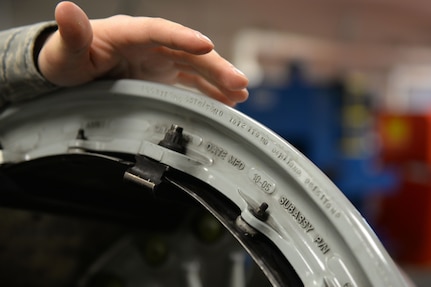 Airman 1st Class Clark Albers, C-17 Globemaster III crew chief and aerospace maintenance journeyman, inspects the removal due date tag of a C-17 Globemaster III wheel in the Wheel and Tire Shop at Joint Base Elmendorf-Richardson, Alaska December 18, 2017. If the RDD tag indicates the wheel is within a certain timeframe of needing replacement, it will be repaired in the shop.