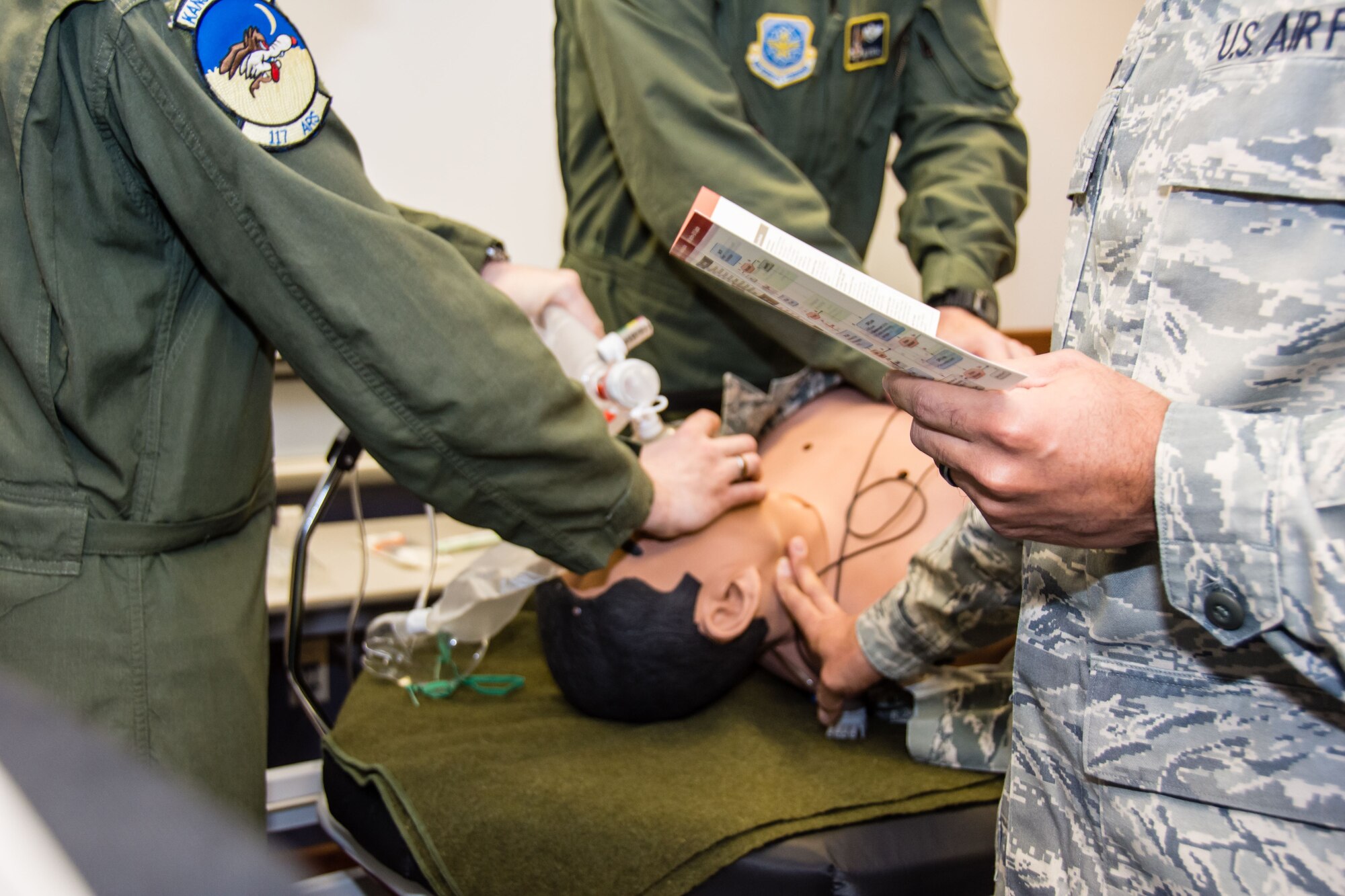 Capt. Ryan Voth and Lt. Col. Jon O’Neal, both members of the 190th Air Refueling Wing Medical Group, practice advanced cardiac life support during the Jan. drill. ALCS is basic life support with extra emphasis on cardiac support. Scenarios like this usually take place in a hospital setting. Training and equipment for these circumstances are not found in the  eld and require a higher echelon of care. (Photo by Staff Sgt. Kayla Kohn.)