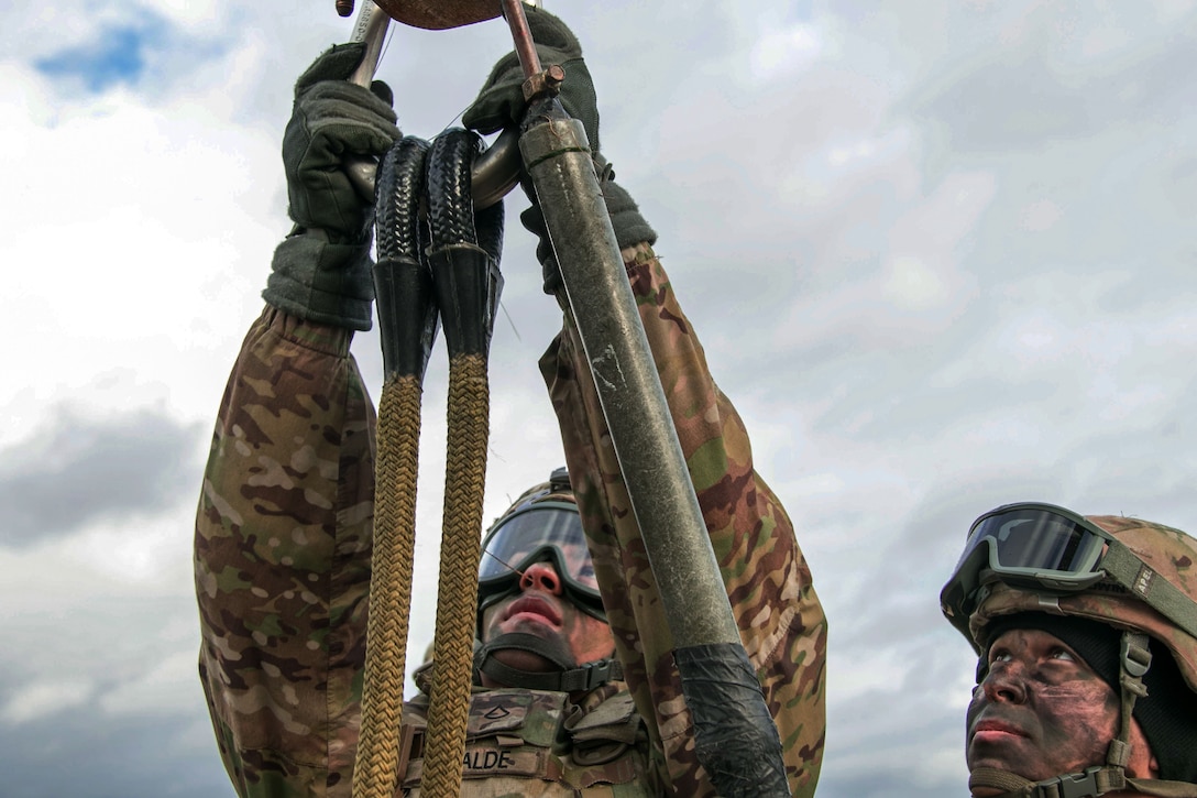Soldiers train on hook-up procedures during a sling load exercise in Skwierzyna, Poland.
