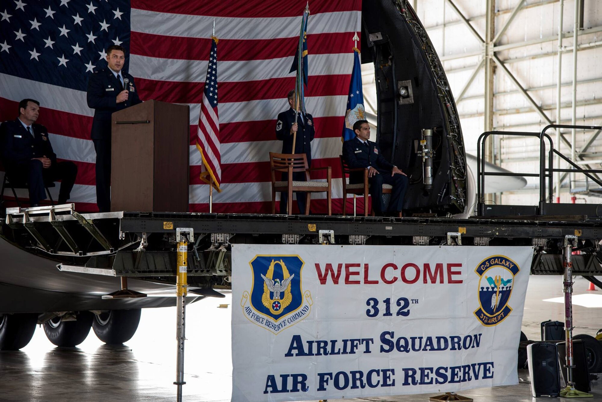 Lt. Col. Ricardo Hiraldo (right), 312th Airlift Squadron commander, accepts the guidon from Lt. Col. Travis Rowley (left), 349th Operations Group commander, during an assumption of command ceremony at Travis Air Force Base, Calif., on Jan. 6, 2018.