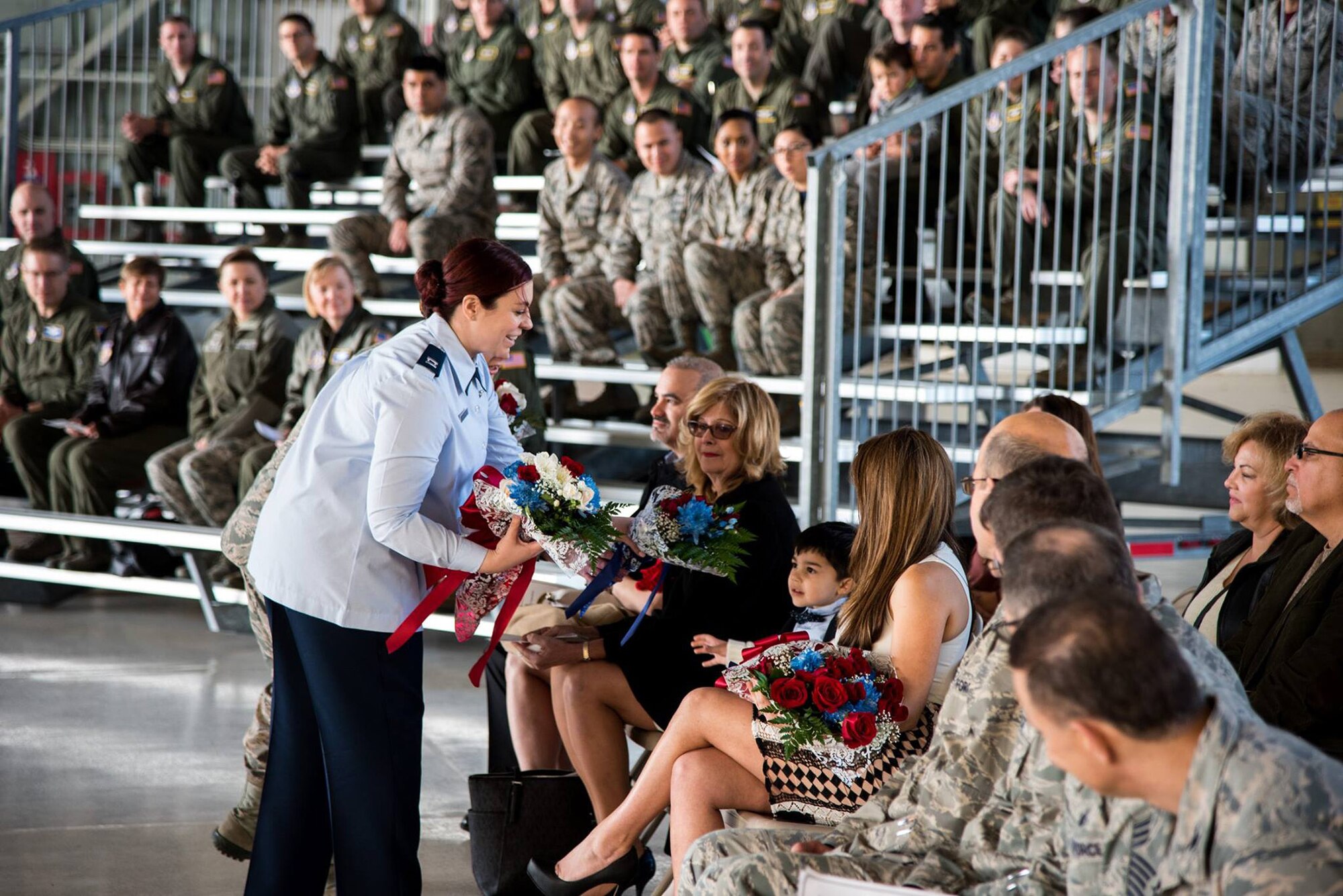 Lt. Col. Ricardo Hiraldo (right), 312th Airlift Squadron commander, accepts the guidon from Lt. Col. Travis Rowley (left), 349th Operations Group commander, during an assumption of command ceremony at Travis Air Force Base, Calif., on Jan. 6, 2018.