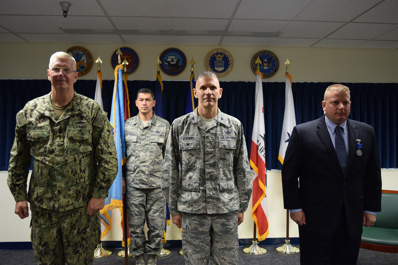 Navy Vice Adm. David Lewis, Defense Contract Management Agency director, left, held a change of leadership ceremony for the agency’s Western Regional Command in Carson, California, Jan. 9. Air Force Col. David Learned, center, relieved David Devlin, right, as the region commander. (DCMA photo by Mark Jackson)