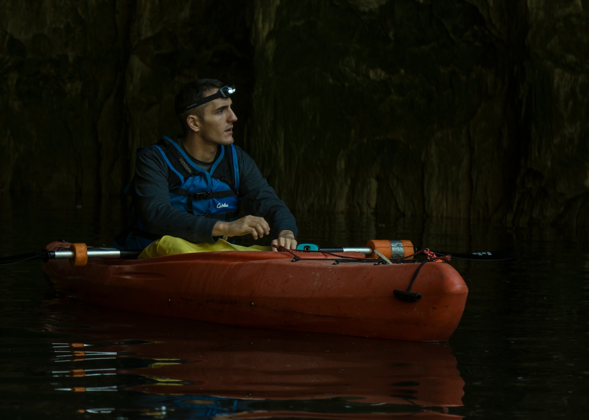 Senior Airman Benjamin Grondin, 375 Communications Squadron cyber transport technician, kayaks on a trip with Scott Air Force Base Outdoor Recreation, Sept. 23, 2017, at Crystal City Underground, an abandoned, submerged sandstone mine in Crystal City, Mo. The yellow tarp he wears over his lap is there to keep the water off of him, as the mine temperatures remain below 60°F year-round. (U.S. Air Force photo by Airman 1st Class Tara Stetler)