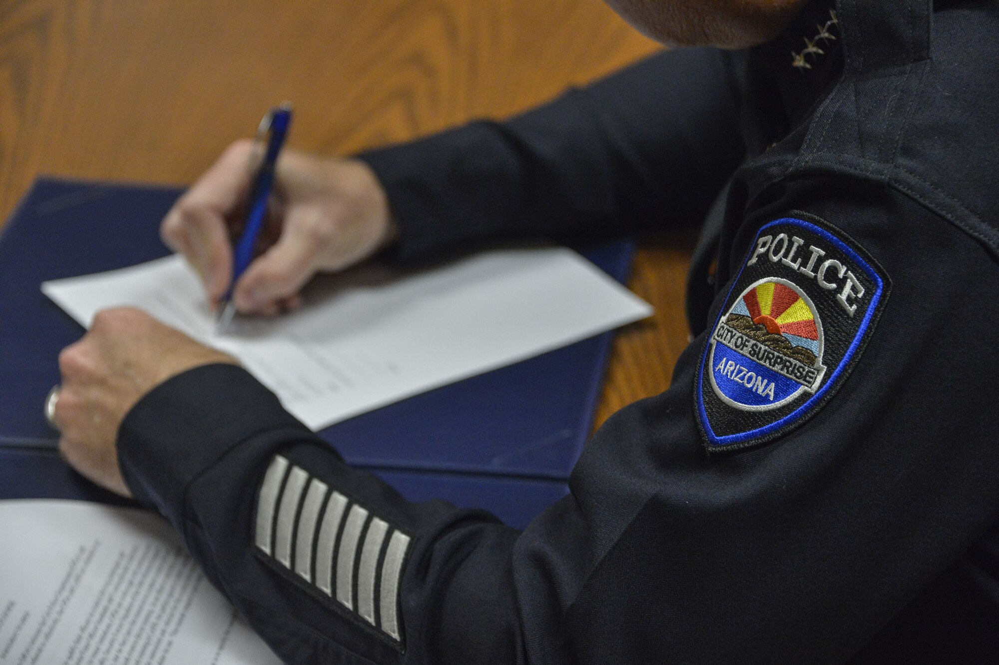 Terry Young, Surprise Police Department police chief, signs the Emergency Vehicle Operators Course Memorandum of Understanding at Luke Air Force Base, Ariz., Jan. 10, 2018. The memorandum allows El Mirage, Peoria and Surprise police departments, in conjunction with 56th SFS members, to train and utilize space and resources at Luke. (U.S. Air Force photo/Airman 1st Class Caleb Worpel)