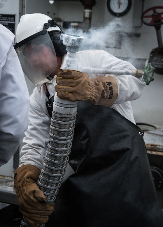 U.S. Air Force Airman 1st Class Jerry Timmons, 673d Logistics Readiness Squadron fuels facilities technician, prepares to fill a 50-gallon liquid oxygen cart at Joint Base Elmendorf-Richardson, Alaska, Dec. 4, 2017. Oxygen is pressurized and cooled into a liquid state in order to transport it more efficiently from cryogenic tanks to JBER’s aircraft to provide fresh air to pilots in flight.