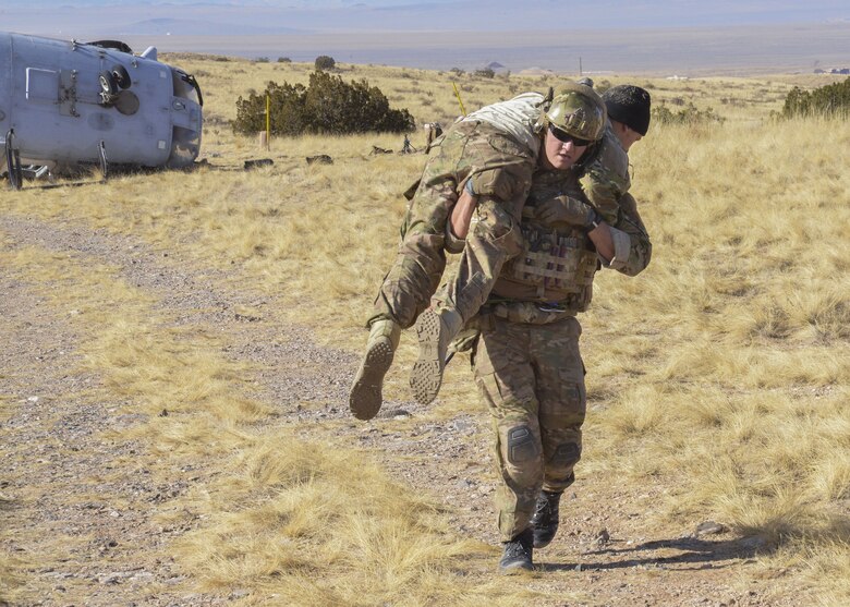 Students from the USAF Pararescue School load patients for aeromedical evacuation during a mass casualty exercise at Kirtland Air Force Base, N.M., Jan. 6. The exercise, part of a sequence of full mission profiles Pararescuemen and Combat Rescue Officer students must face before graduation, included more than 100 Airmen and Soldiers. Members of the 3-501st Air Assault Brigade from Fort Bliss, Texas, provided the air component with UH-60 Blackhawk helicopters.