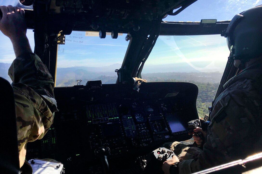 California Air National Guard pilots fly an HH-60G Pave Hawk rescue helicopter.