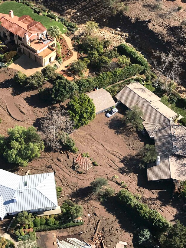 An aerial view taken from a HH-60G Pave Hawk rescue helicopter shows the massive devastation caused by a mud slide.