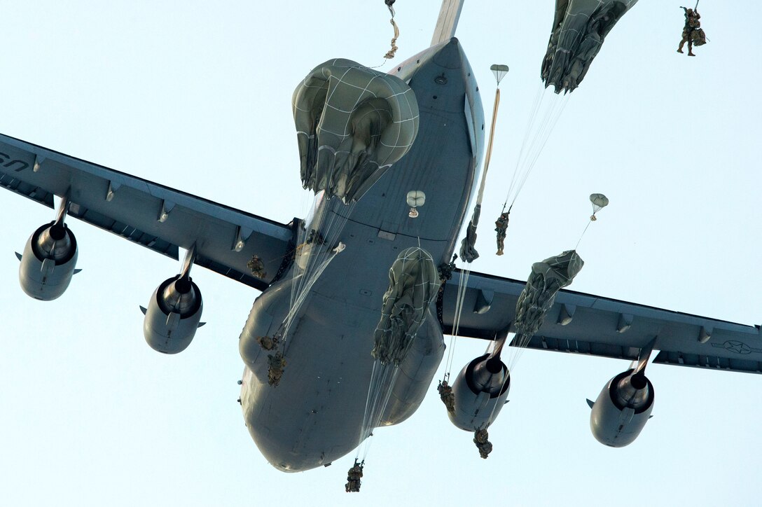 Soldiers jump from an Air Force C-17 Globemaster III during airborne training.