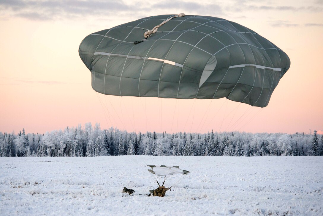 A soldier lands on Malemute drop zone during airborne jump training.