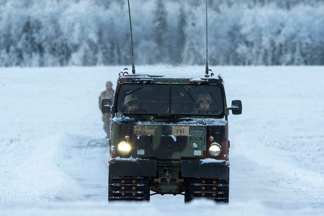 Soldiers operate a tactical snow vehicle at Malemute drop zone during airborne training.