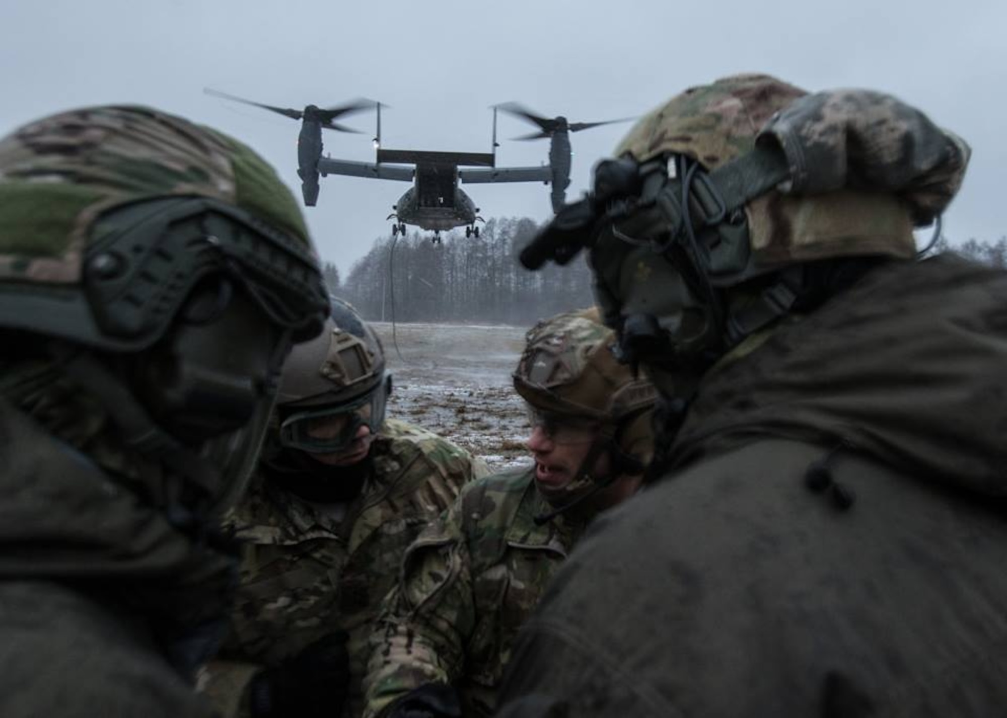 Estonian and U.S. Special Operation Forces operators prepare to board a U.S. Air Force CV-22 Osprey, assigned to the 352d Special Operations Wing, during fast rope training near Amari, Estonia, Dec. 12, 2017. Estonian and U.S. SOF conducted Fast Rope Insertion and Extraction System training to build combined NATO SOF readiness.