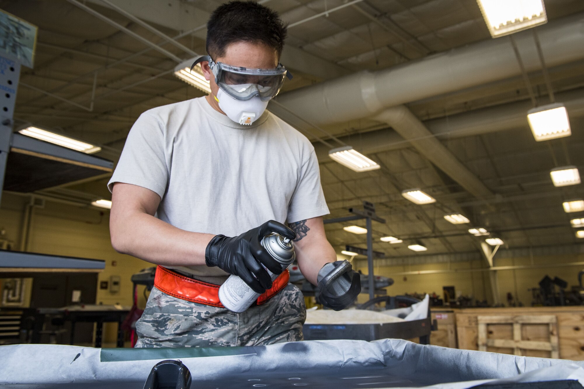 Airman 1st Class Vernon Datu, 23d Maintenance Squadron gun element member, paints metal elements with anti-corrosion spray, Jan. 10, 2018, at Moody Air Force Base, Ga. Moody’s armament flight is responsible for maintaining all of the aircraft weapons systems components when they're removed from the aircraft. This includes gun systems, alternate mission equipment and bomb racks. (U.S. Air Force photo by Senior Airman Janiqua P. Robinson)