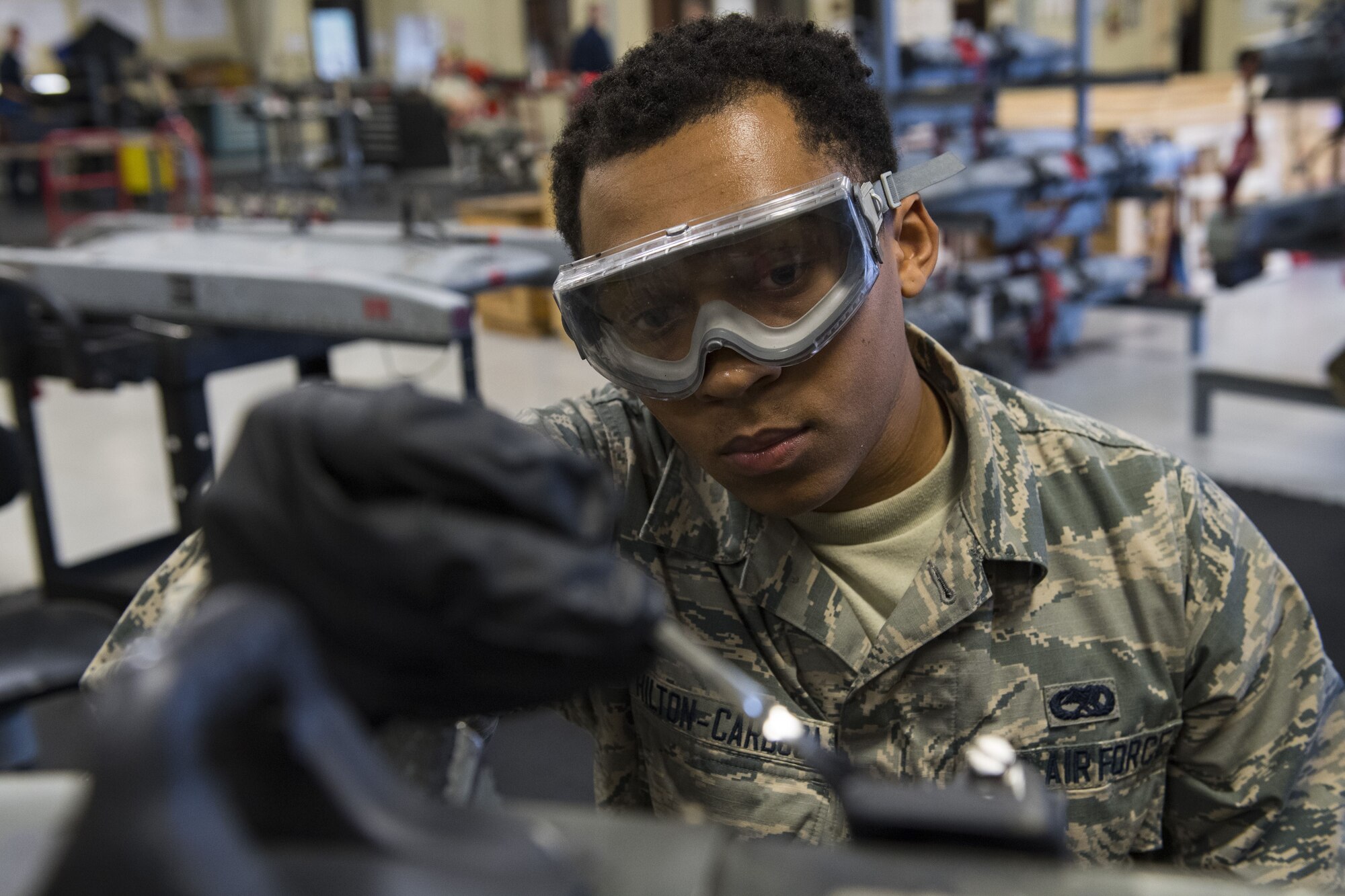 Airman 1st Class DeAndre Hilton-Cardoza, 23d Maintenance Squadron armament apprentice, paints metal elements with anti-corrosion spray, Jan. 10, 2018, at Moody Air Force Base, Ga. Moody’s armament flight is responsible for maintaining all of the aircraft weapons systems components when they're removed from the aircraft. This includes gun systems, alternate mission equipment and bomb racks. (U.S. Air Force photo by Senior Airman Janiqua P. Robinson)