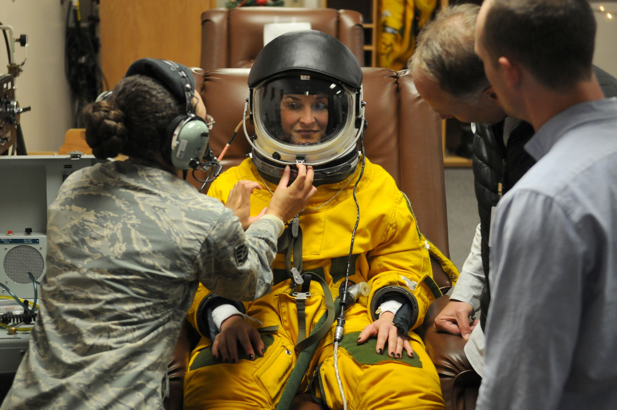 Katherine Segovia, Executive Education Head of Learning Experience Design at Stanford University Design School, is assisted while putting on an Air Force U-2 Dragon Lady flight suit as part of her visit for a design thinking seminar on the Inaugural Design Day