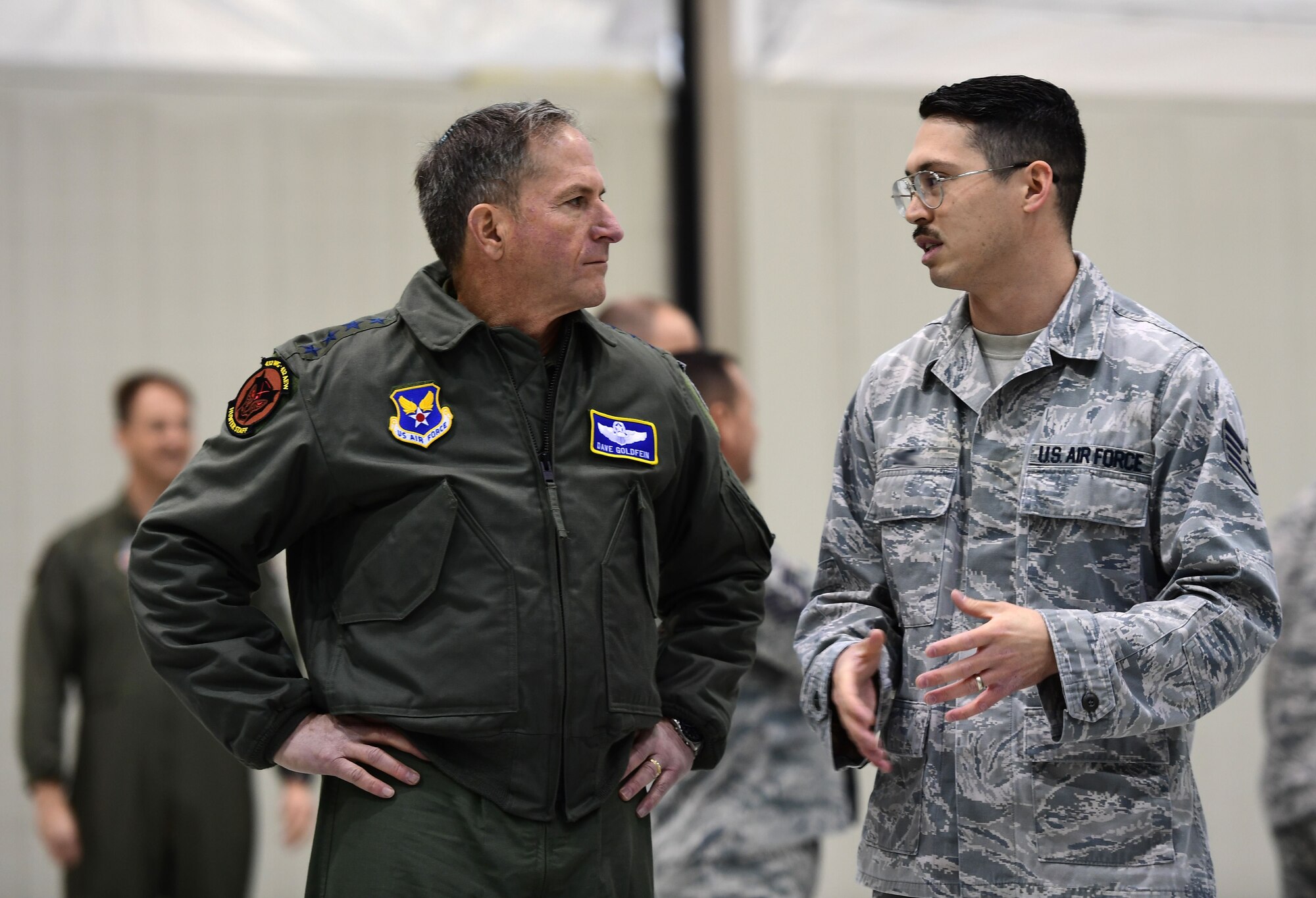Air Force Chief of Staff Gen. David L. Goldfein discusses MQ-9 Reaper avionics from Staff Sgt. Michael, 432nd Aircraft Maintenance Squadron avionics technician, Jan. 9, 2017, at Creech Air Force Base, Nev. Goldfein toured operational squadrons around the base to meet with 432nd Wing/432nd Air Expeditionary Wing and 799th Air Base Group Airmen.  (U.S. Air Force photo/Senior Airman Christian Clausen)