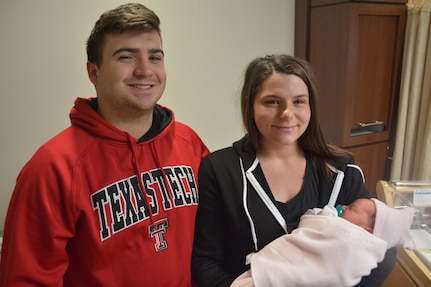 Petty Officer 1st Class Dylan Pendleton and his wife, Rachel, pose for a photo with their daughter, Violet. The 8-pound, 14-ounce, 20.2 inch baby girl was born at 2:27 a.m. Jan. 1, 2018. Violet was BAMC's first baby in the New Year.