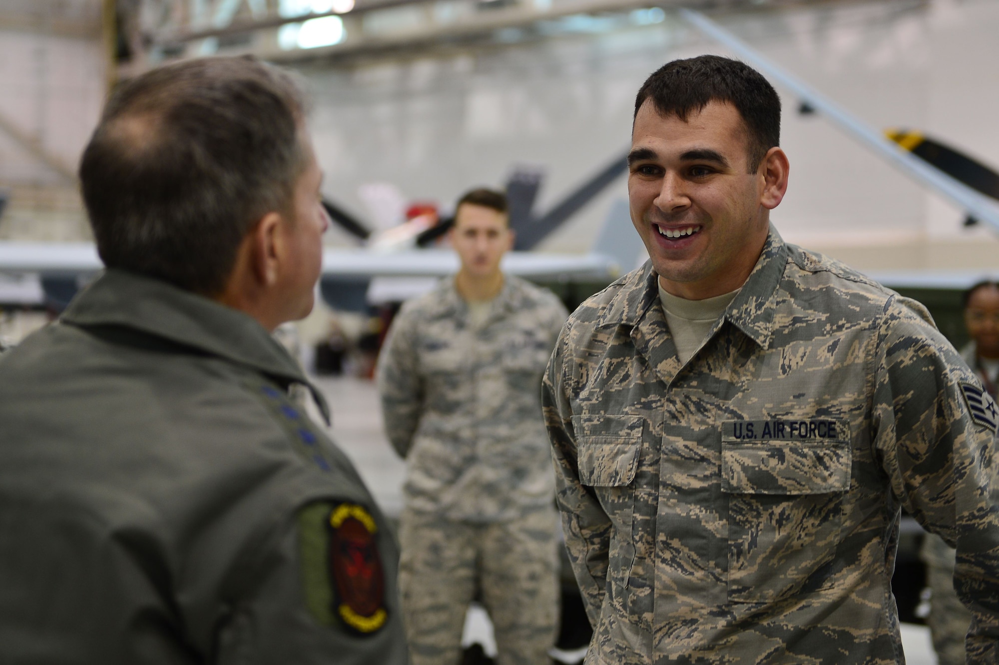 Air Force Chief of Staff Gen. David L. Goldfein shares a laugh with Staff Sgt. Steven, 432nd Aircraft Maintenance Squadron aircraft technician, Jan. 9, 2017, at Creech Air Force Base, Nev. Goldfein visited to see operations firsthand and discuss the future of the Remotely Piloted Aircraft enterprise. (U.S. Air Force photo/Airman 1st Class Haley Stevens)