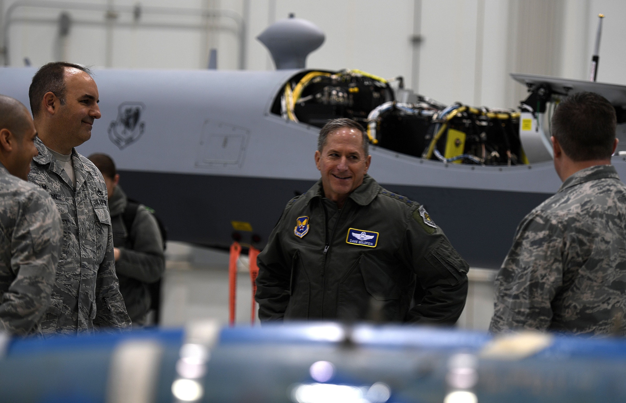 Air Force Chief of Staff Gen. David L. Goldfein speaks to Col. Matthew, 432nd Maintenance Group commander, about the benefits of deploying MQ-9 Reapers in the fight against Islamic State of Iraq and Syria during his visit to Creech Air Force Base, Nev., Jan. 9, 2018. Goldfein visited with the 432nd Wing/432nd Air Expeditionary Wing and 799th Air Base Group Airmen who deliver persistent attack and reconnaissance 24/7/365 against the nation’s enemies. (U.S. Air Force photo/Master Sgt. Nadine Barclay)