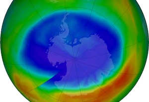 A graphic of the Earth shows a large purple and blue circle which are areas with the least ozone.