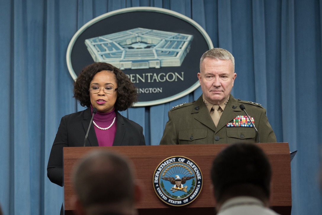 The chief Pentagon spokesperson and a Marine Corps general speak at a podium.