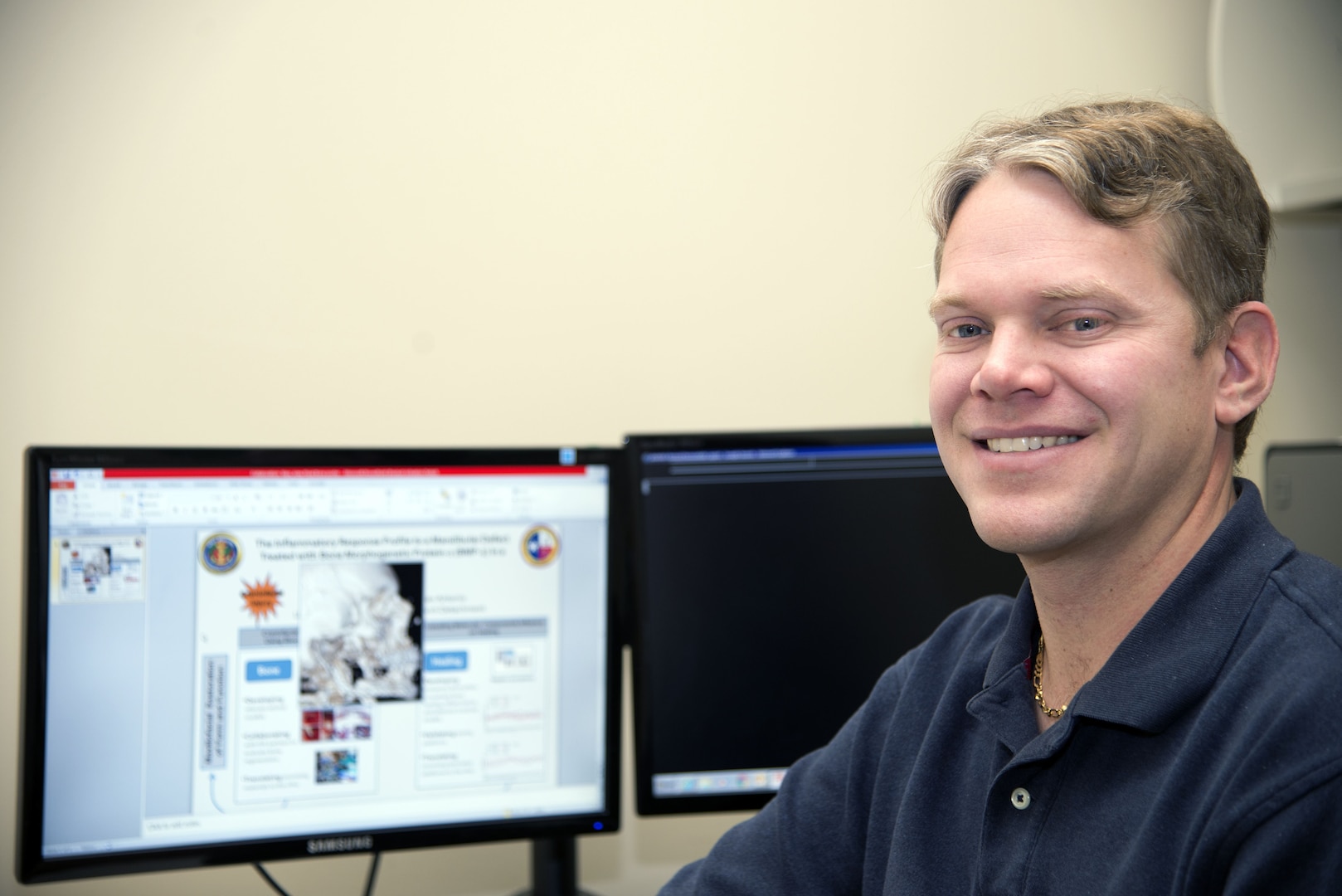 Dr. Alexander Burdette, Naval Medical Research Unit San Antonio principal investigator, uses a computer display in his office at Joint Base San Antonio-Fort Sam Houston to show a process for bone regeneration. Burdette is involved in a research project to find if the use of biological therapeutics can provide a better method for bone regeneration that could improve treatment for service members and patients whose bone tissue has been damaged by a traumatic injury.