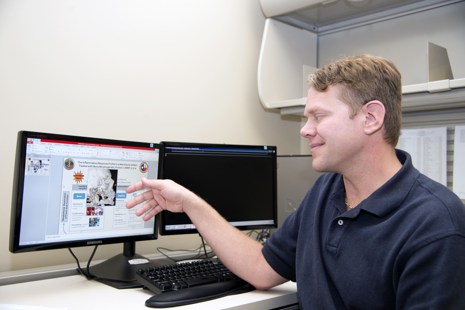 Dr. Alexander Burdette, Naval Medical Research Unit San Antonio principal investigator, uses a computer display in his office at Joint Base San Antonio-Fort Sam Houston to show a process for bone regeneration. Burdette is involved in a research project to find if the use of biological therapeutics can provide a better method for bone regeneration that could improve treatment for service members and patients whose bone tissue has been damaged by a traumatic injury.