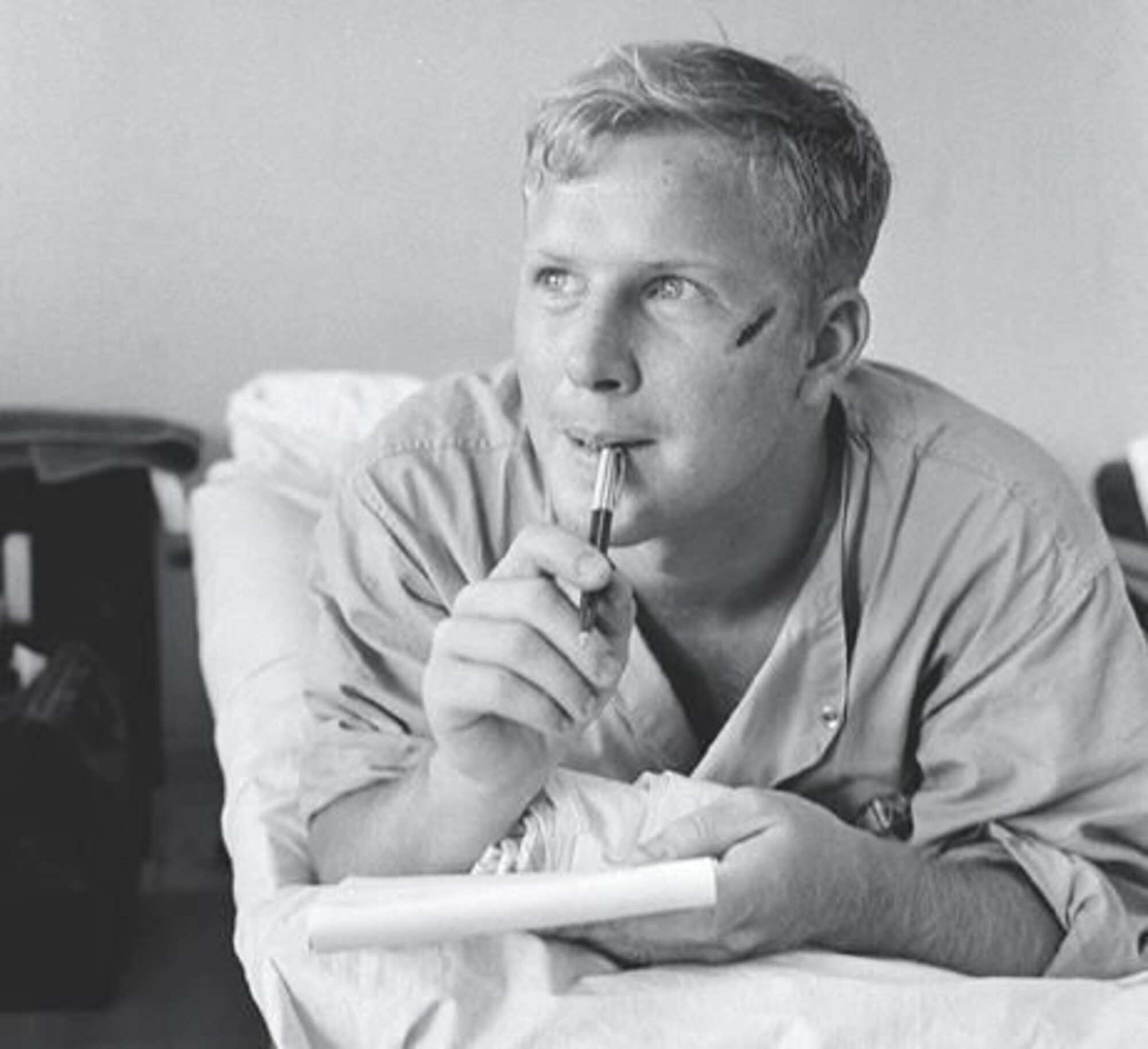 Army medic Thomas Cole writes a letter home while recovering from a head wound at the Third Field Hospital in Saigon on Feb. 19, 1966. Cole made national headlines when a photo of him appeared on the cover of Life magazine. That photo is on the cover of this month’s VFW. (Photo by Henri Huet/AP)