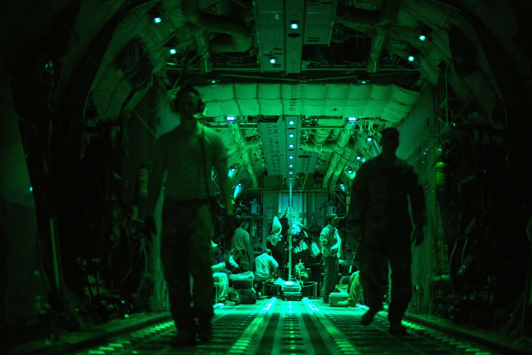 Airmen take a break after offloading pallets of cargo from a C-130J Super Hercules.