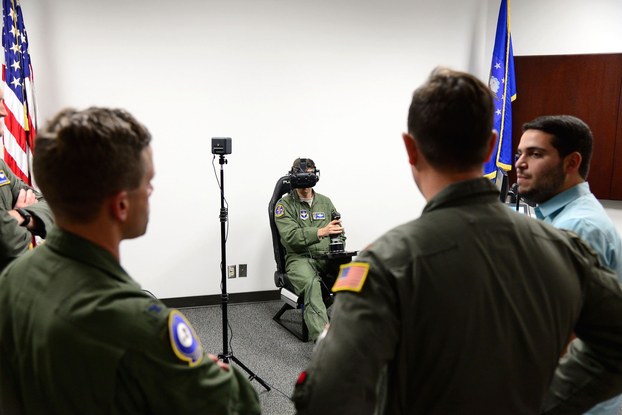 Col. William Denham, 14th Flying Training Wing Vice Commander, and the Adaptive Flight Training Study research team look onto Lt. Col. Marc Deshaies, 14th Student Squadron Commander as he flies a virtual aircraft Jan. 9, 2018, on Columbus Air Force Base, Mississippi. The study was held primarily to find out if the VR environment would help adults learn at or above the rates they are currently learning, and how the brain works and reacts in conjunction with other parts of the body during the learning process.
 (U.S. Air Force photo by Airman 1st Class Keith Holcomb)