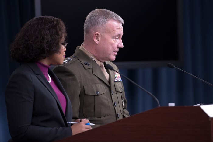 The chief Pentagon spokesperson and a Marine Corps general speak at a podium.