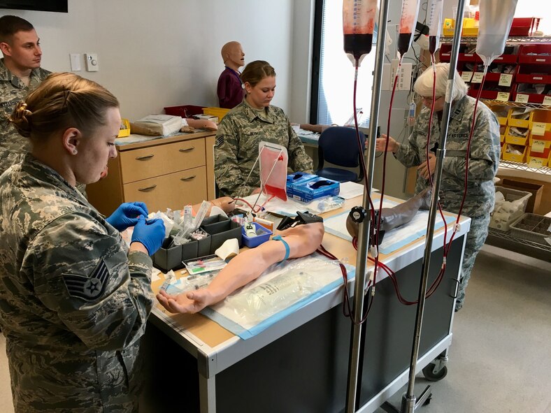 Students train on intravenous line placement and medication administration on artificial arms. The 88th Medical Group simulation center offers training for medical professionals in a realistic setting allowing them to assess, treat and monitor simulated patients. (U.S. Air Force Photo/Johnny Cartwright)