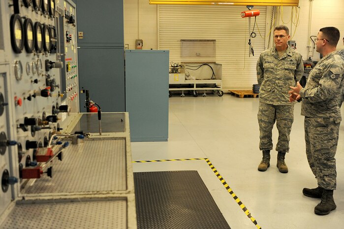 U.S. Air Force Staff Sgt. Brian Waldbillig, left, 437th Maintenance Squadron hydraulic system journeyman, discusses the capabilities and costs to run the hydraulic test stand with U.S. Air Force Brig. Gen. Steven J. Bleymaier, director of logistics, engineering and force protection, Headquarters Air Mobility Command, Scott Air Force Base, Ill at Joint Base Charleston, Jan. 10, 2018. Bleymaier visited JB Charleston to get a better understanding of joint operational capabilities and to meet with services members.