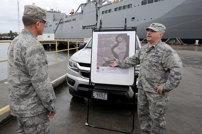 U.S. Air Force Capt. Steven Braddick, right, 628th Civil Engineer Squadron Weapons Station element chief briefs U.S. Air Force Brig. Gen. Steven J. Bleymaier, director of logistics, engineering and force protection, Headquarters Air Mobility Command, Scott Air Force Base, Ill about the importance of dredging every 18 months so prepositioned ships can enter Wharf Alpha at Joint Base Charleston – Weapons Station, Jan. 10, 2018. General Bleymaier visited JB Charleston to get a better understanding of joint operational capabilities and to meet with services members.