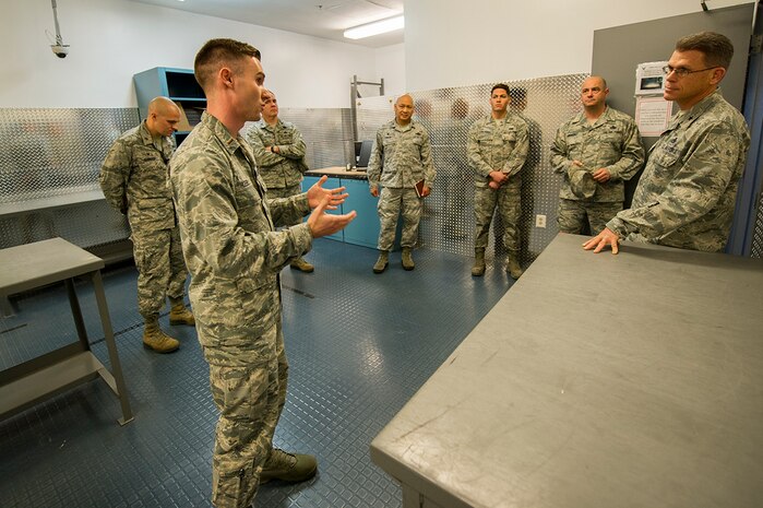 U.S. Air Force 2nd Lt. Robert “Bo” Huebel, left, 437th Aircraft Maintenance Squadron sortie support flight commander, briefs Brig. Gen. Steven J. Bleymaier, director of logistics, engineering and force protection, Headquarters Air Mobility Command, Scott Air Force Base, Ill at Joint Base Charleston. Jan. 10, 2018.