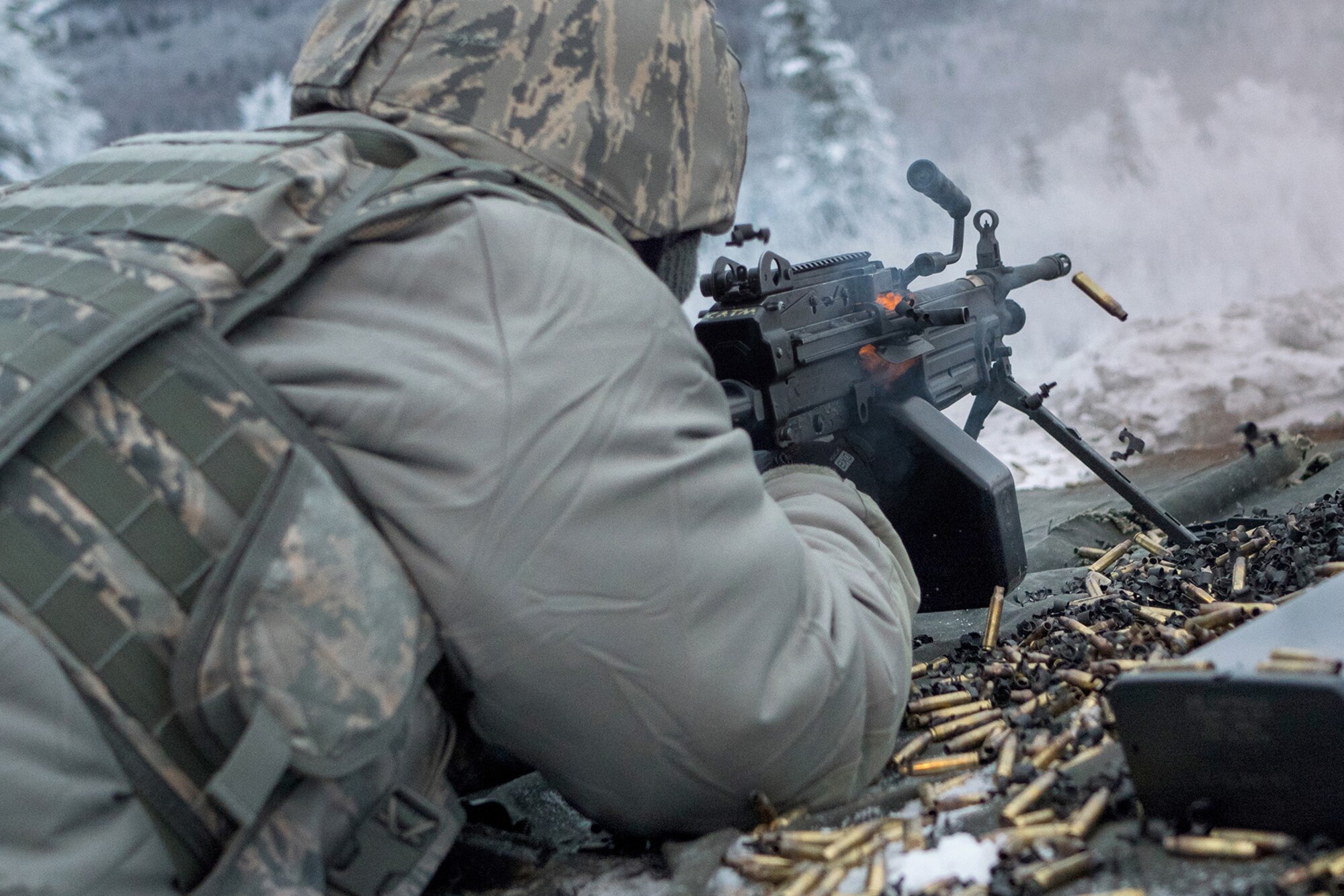 Airman 1st Class Benjie Duenas, a native of Saipan, assigned to the 673d Security Forces Squadron, fires at a target with an M249 Squad Automatic Weapon during a machine gun qualification range on Joint Base Elmendorf-Richardson, Alaska, Jan. 10, 2018. Security Forces Airmen perform extensive training in law enforcement as well as combat tactics to protect U.S. Military bases and assets both stateside and overseas.
