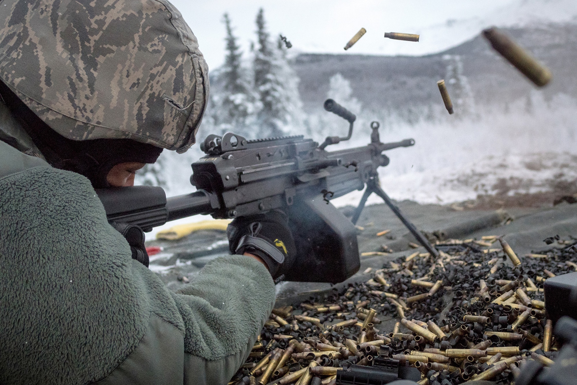 Airman 1st Class Kaylon Thomas, a native of Conway, Ark., assigned to the 673d Security Forces Squadron, fires an M249 Squad Automatic Weapon, as Airmen conduct a machine gun qualification range on Joint Base Elmendorf-Richardson, Alaska, Jan. 10, 2018. Security Forces Airmen perform extensive training in law enforcement as well as combat tactics to protect U.S. Military bases and assets both stateside and overseas.