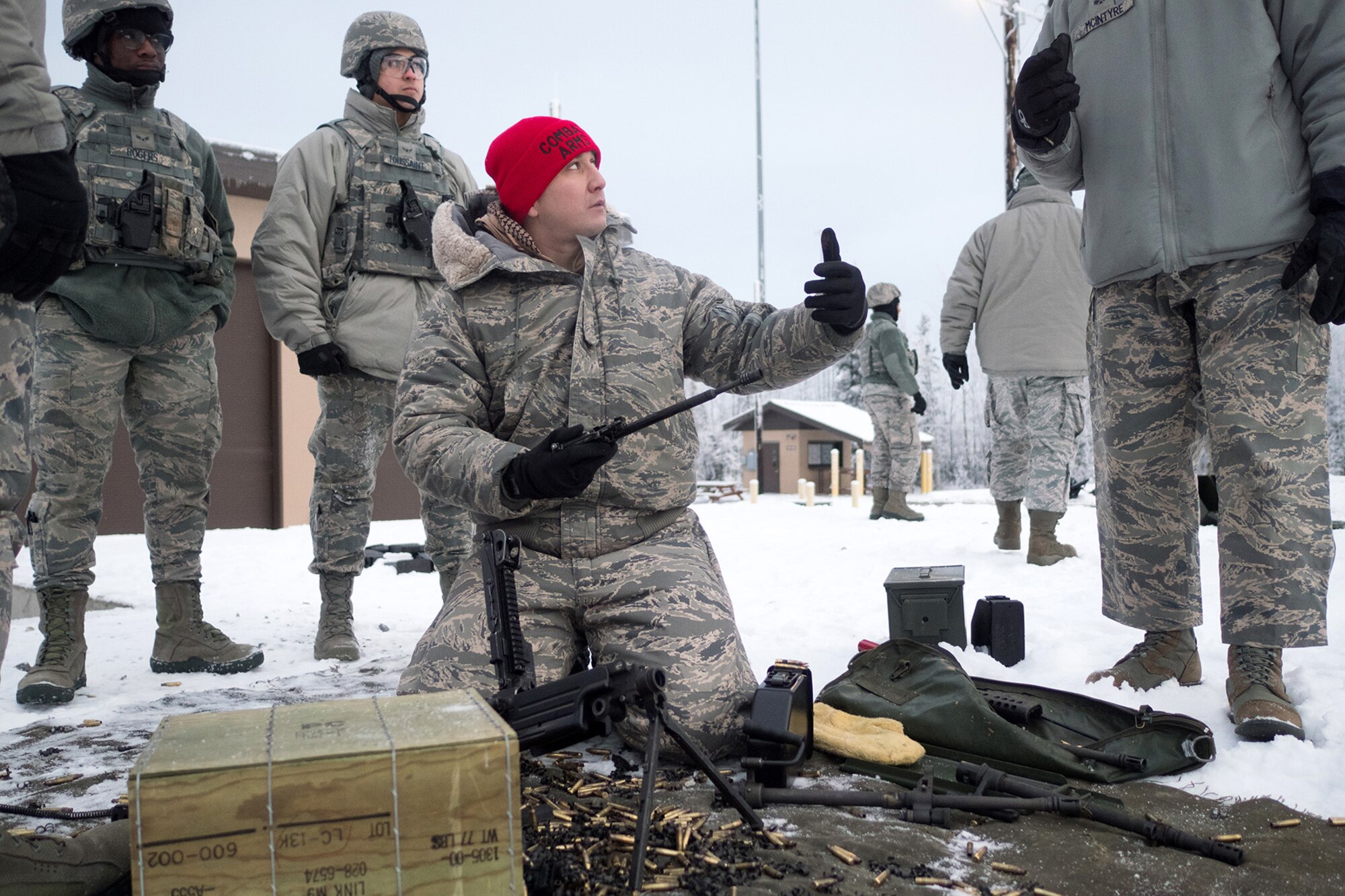 Air Force Staff Sgt. Ruben Salazar, a native of Hansen, Idaho, assigned to the 673d Security Forces Squadron, instructs Airmen on  maintenance of an M249 Squad Automatic Weapon 5.56mm, during a machine gun qualification range on Joint Base Elmendorf-Richardson, Alaska, Jan. 10, 2018. Security Forces Airmen perform extensive training in law enforcement as well as combat tactics to protect U.S. Military bases and assets both stateside and overseas.