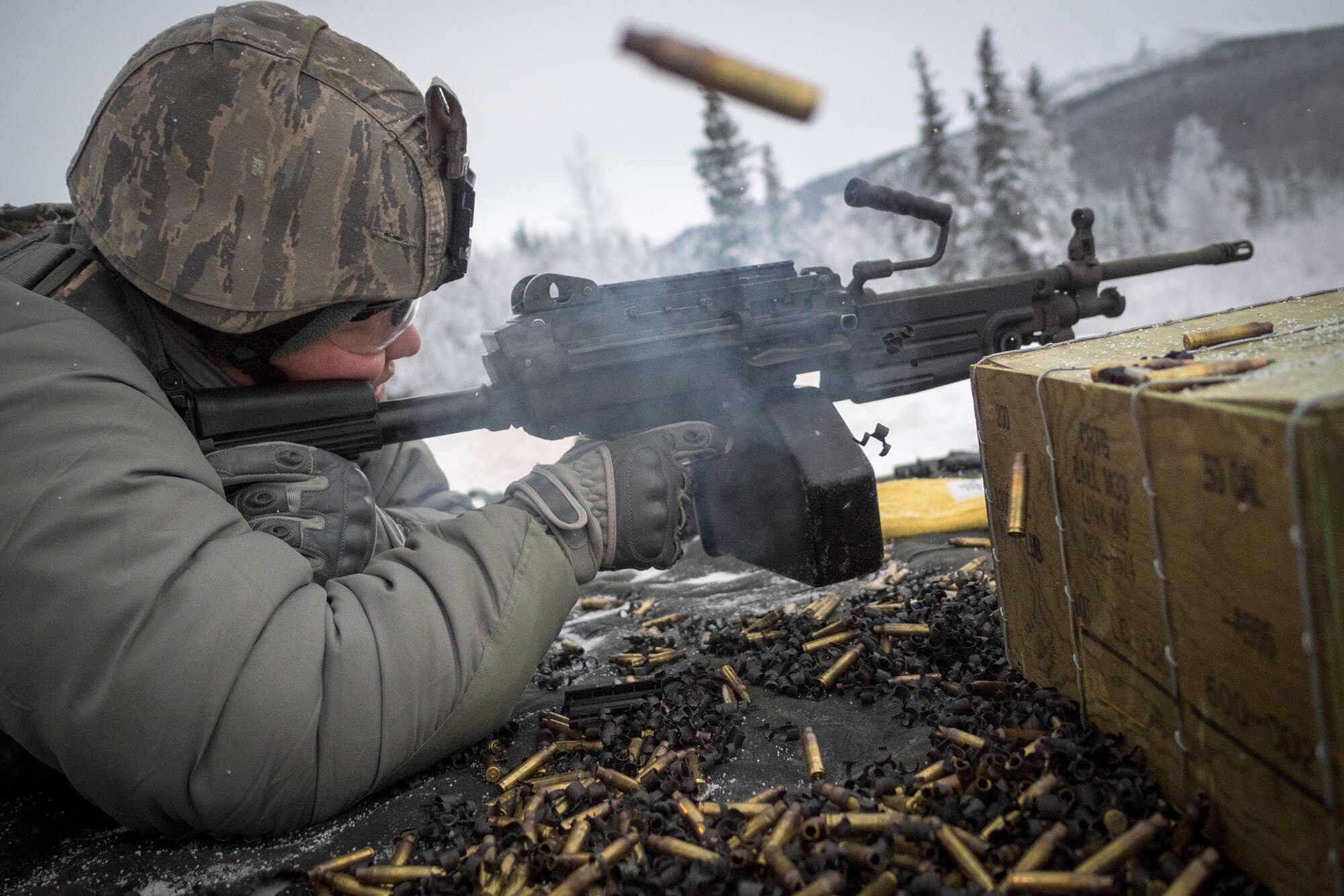 Senior Airman Tina-Louise Dunbar, a native of Anchorage, Alaska, assigned to the 673d Security Forces Squadron, fires on a target with an M249 Squad Automatic Weaponduring a machine gun qualification range on Joint Base Elmendorf-Richardson, Alaska, Jan. 10, 2018. Security Forces Airmen perform extensive training in law enforcement as well as combat tactics to protect U.S. Military bases and assets both stateside and overseas.