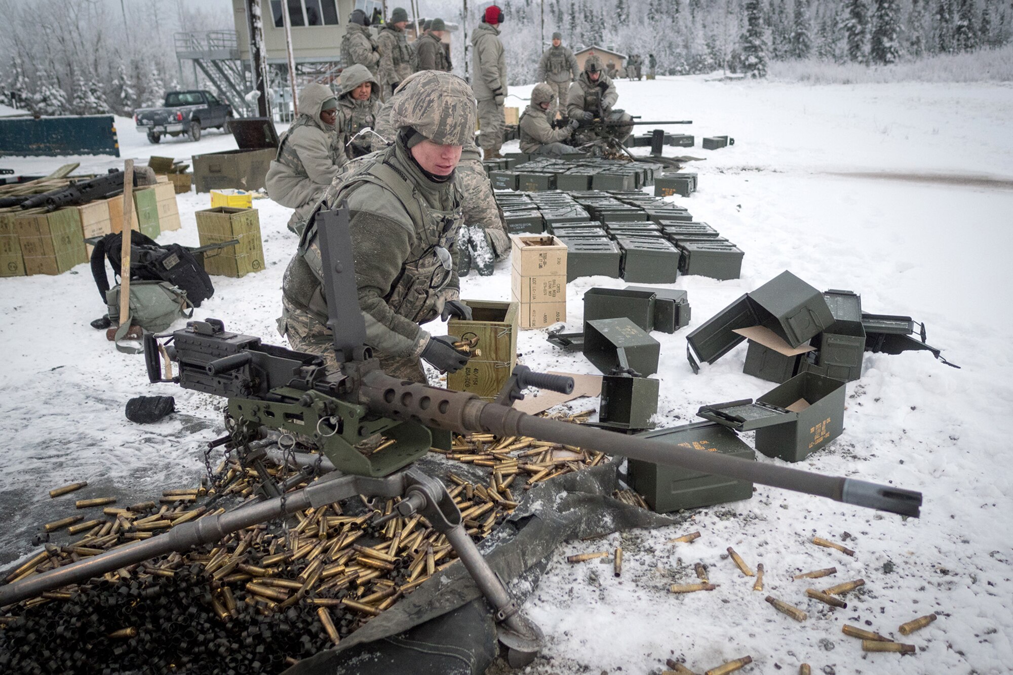 Airman 1st Class Robert Boyer, assigned to the 673d Security Forces Squadron, picks up expended .50 caliber casings after conducting an M249 Squad Automatic Weapon, and M2 .50 Caliber machine gun qualification range on Joint Base Elmendorf-Richardson, Alaska, Jan. 10, 2018. Security Forces Airmen perform extensive training in law enforcement as well as combat tactics to protect U.S. Military bases and assets both stateside and overseas.