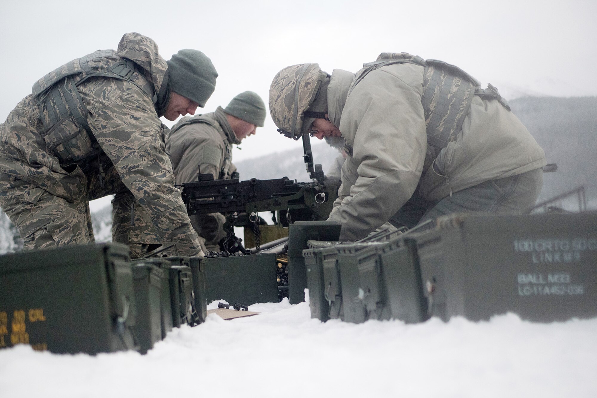 Airmen assigned to the 673d Security Forces Squadron pick up expended casings after conducting a machine gun qualification range on Joint Base Elmendorf-Richardson, Alaska, Jan. 10, 2018. Security Forces Airmen perform extensive training in law enforcement as well as combat tactics to protect U.S. Military bases and assets both stateside and overseas.