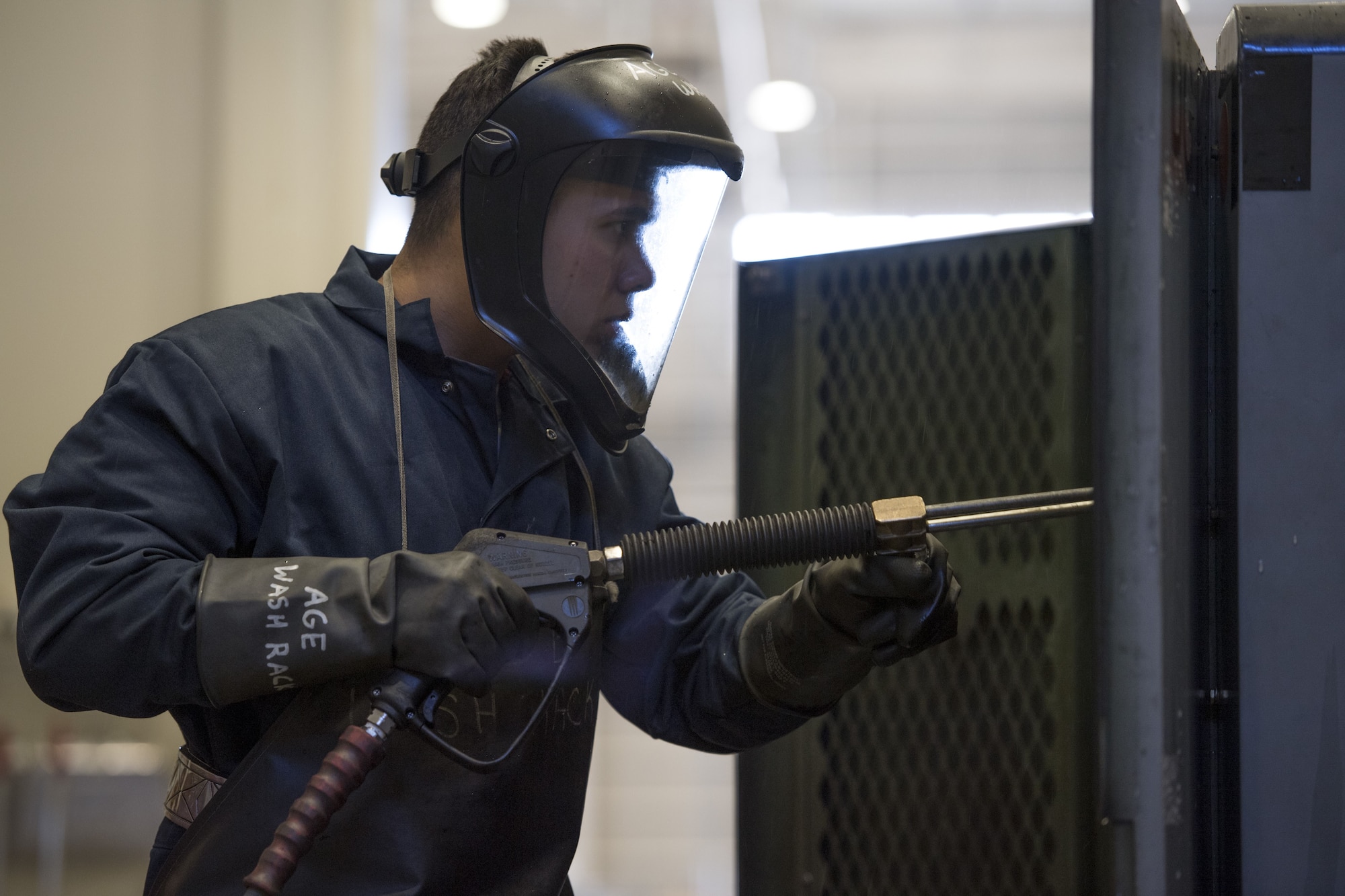 A 374th Maintenance Squadron aerospace ground equipment technician cleans flightline machinery, Jan. 10, 2018, at Yokota Air Base, Japan.