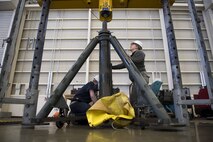 Airman 1st Class Sommer Lax, 374th Maintenance Squadron aerospace ground equipment technician, guides a 60 ton aircraft jack into place in a universal jack tester, Jan. 10, 2018, at Yokota Air Base, Japan.