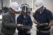 Airmen with the 374th Maintenance Squadron aerospace ground equipment flight work together to double check proper inspection regulations, Jan. 10, 2018, at Yokota Air Base, Japan.