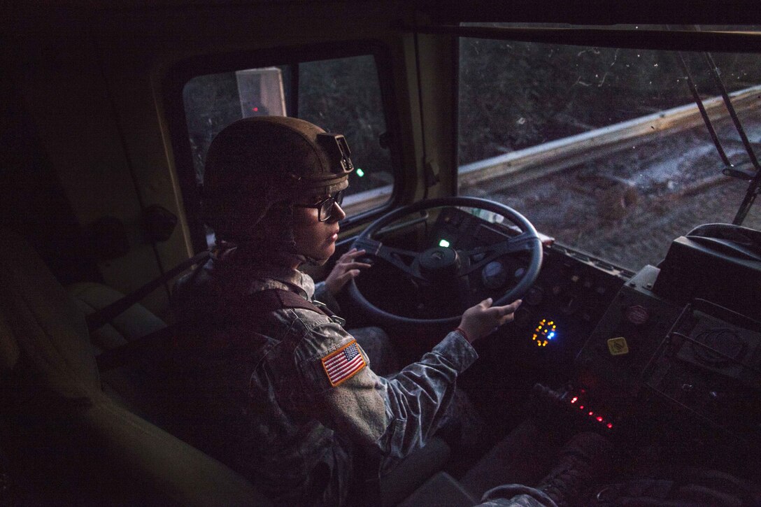 Sgt. Diana Martinez drives a light medium tactical vehicle through an area closed after a storm-driven mudslide.