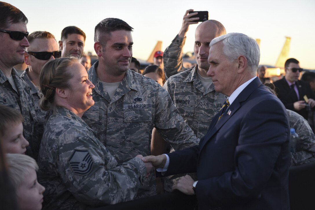 Vice President Mike Pence shakes hands with airmen.
