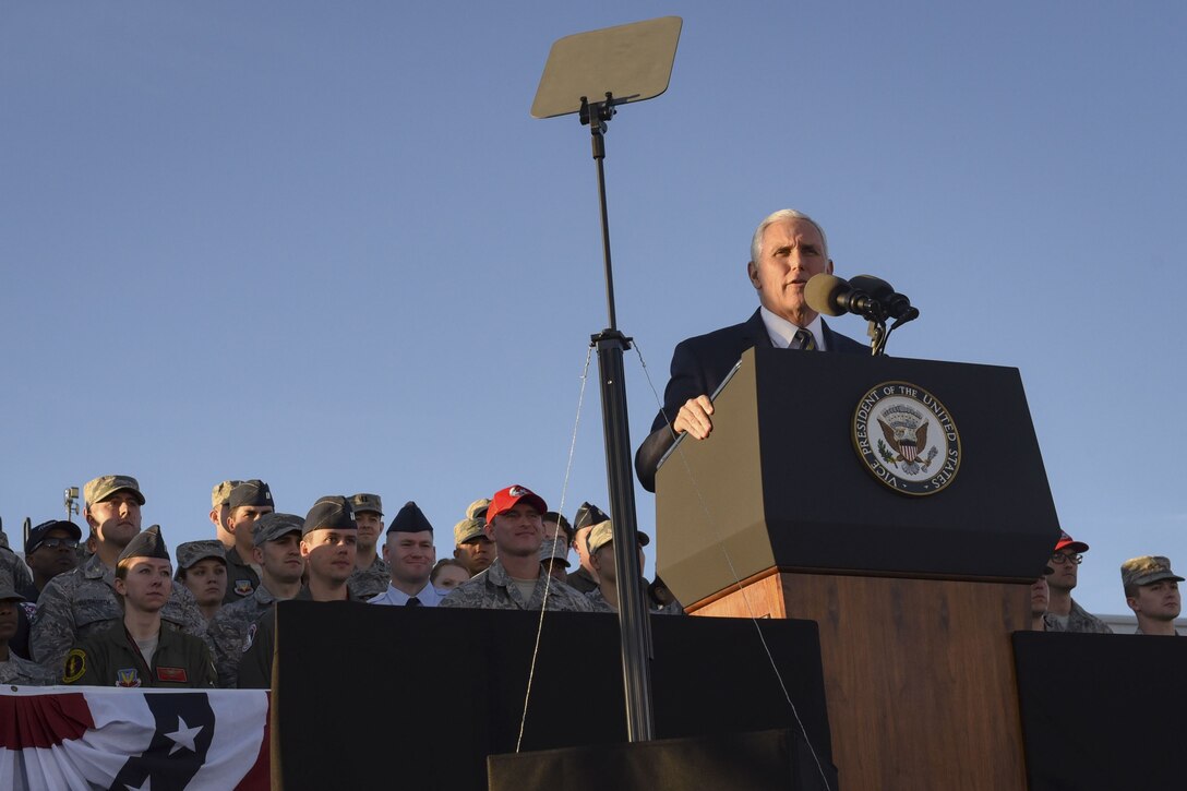 Vice President Mike Pence addresses airmen from behind a podium.